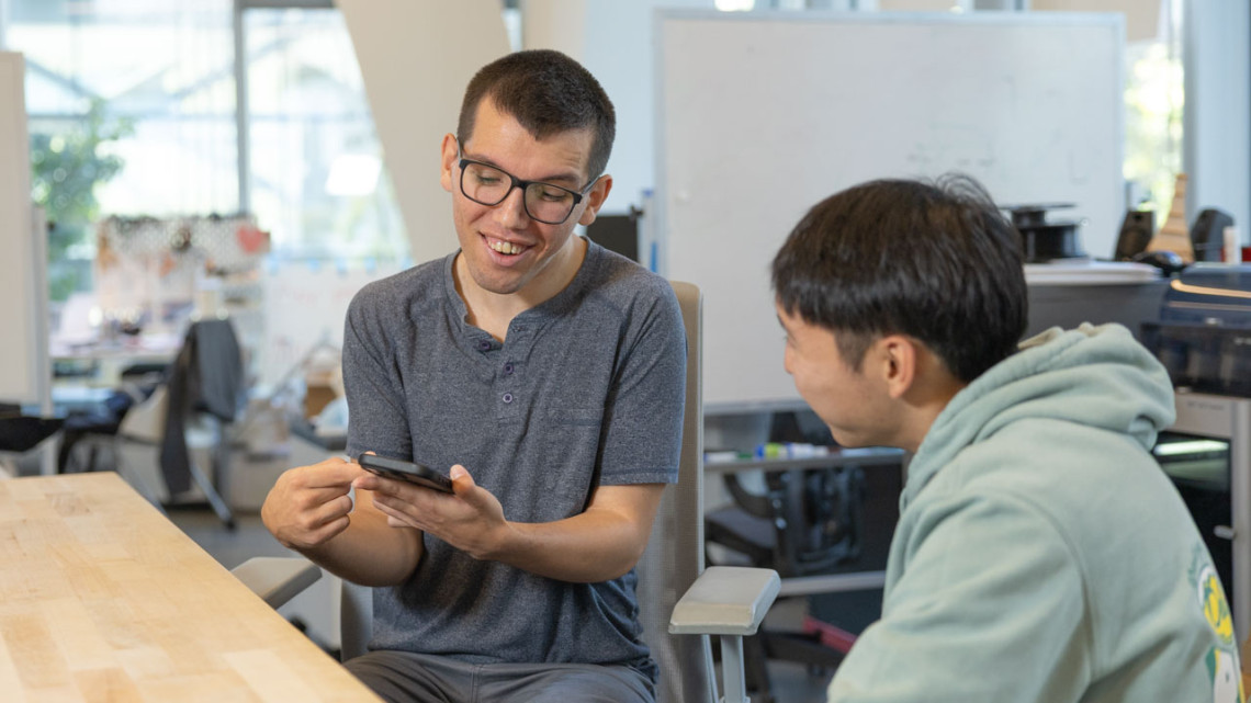 By Alexandra Bayer/Cornell University Doctoral student Tobias Weinberg communicates with another student using alternative augmentative and alternative communication (AAC) software he developed.