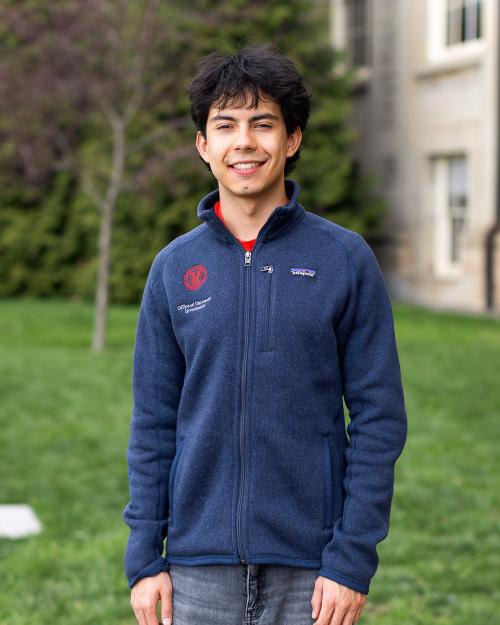 A color photo of a man smiling for a photo.