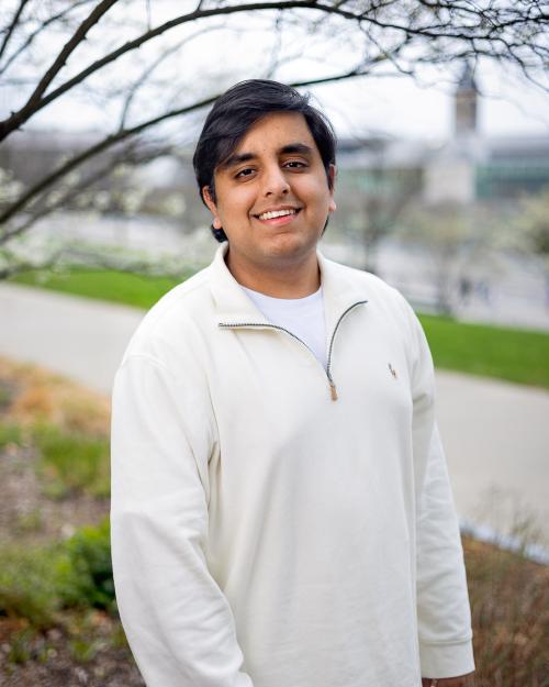 A color photo of a man smiling for a photo.