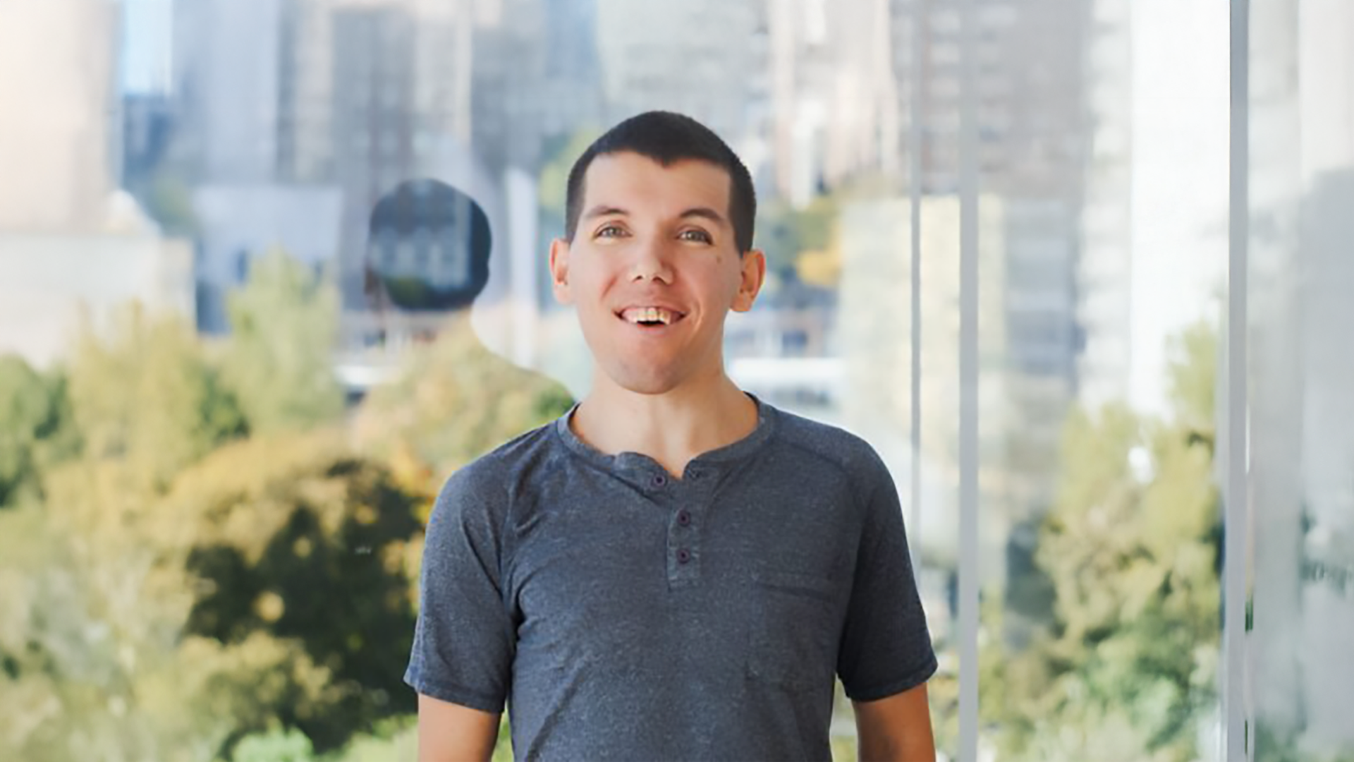 A color photo of a man smiling for a photo.