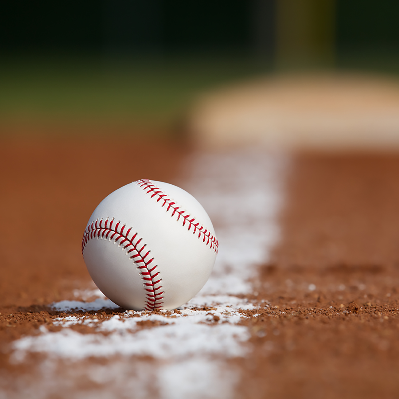 Baseball on the Infield Chalk Line with the Base in the distance. Shutterstock