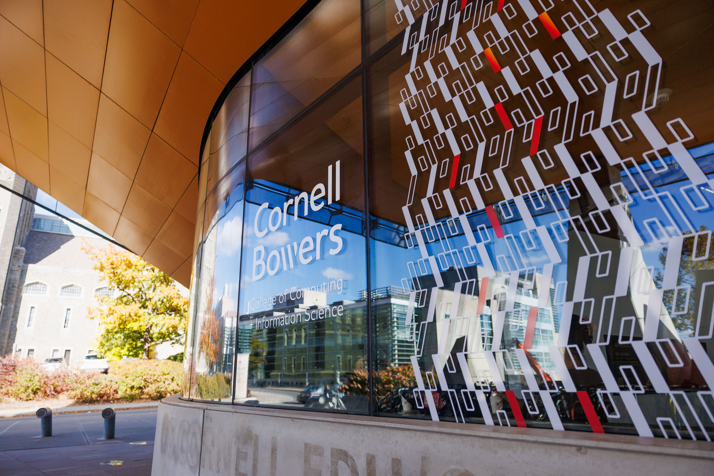 Color photo showing a window decal for Cornell Bowers.