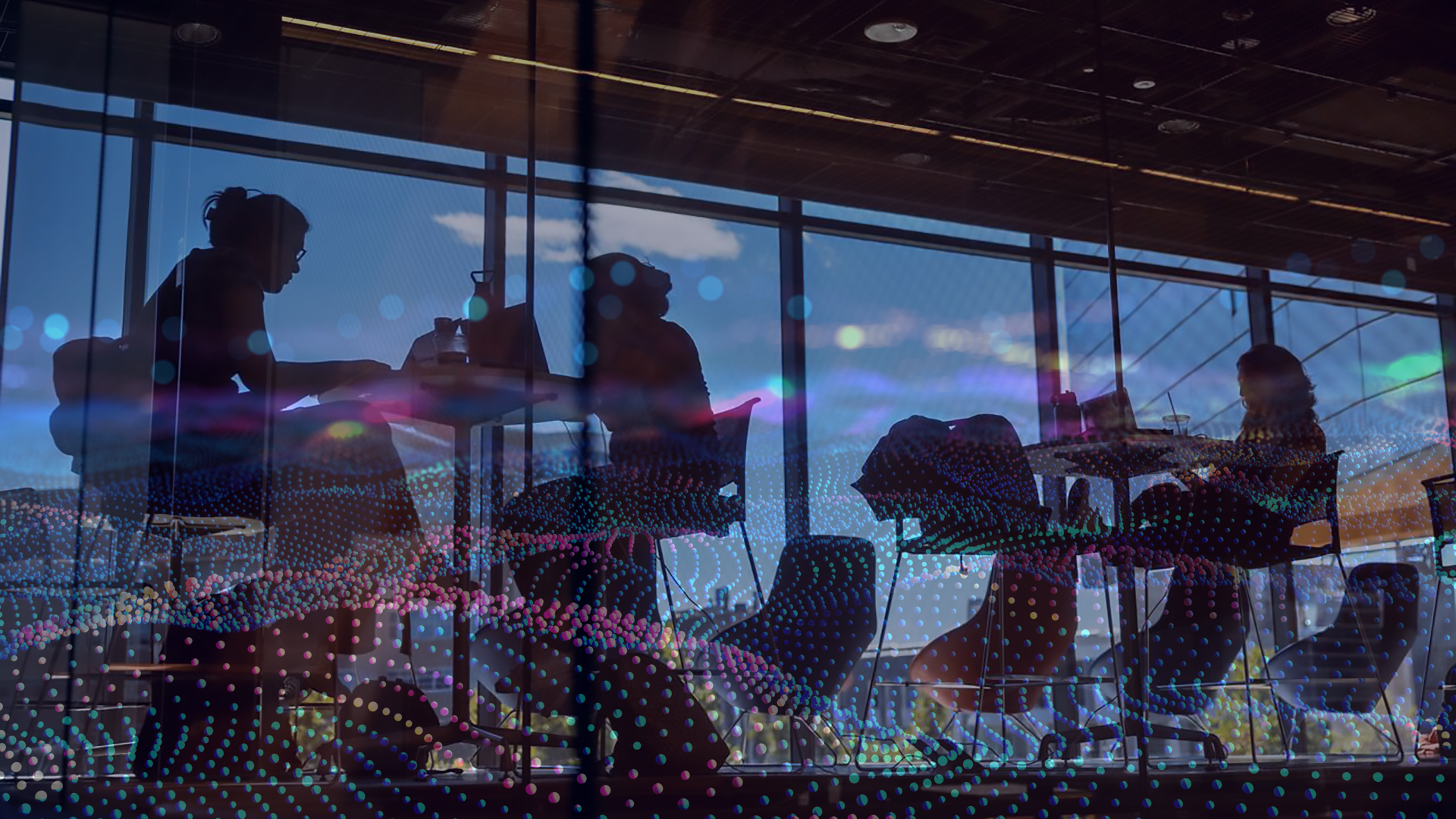 A color graphic showing the silhouettes of students with wavy colorful dot overlaying the photo.