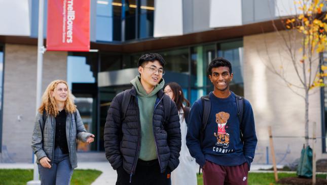 four students walking outside
