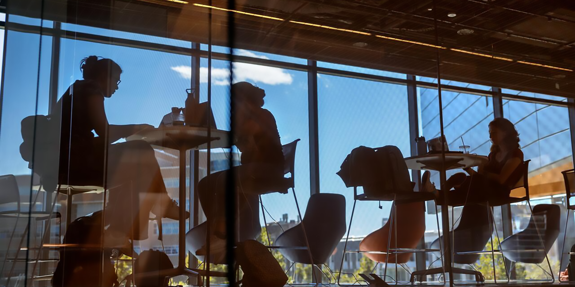 A color photo showing students working in a lounge area.