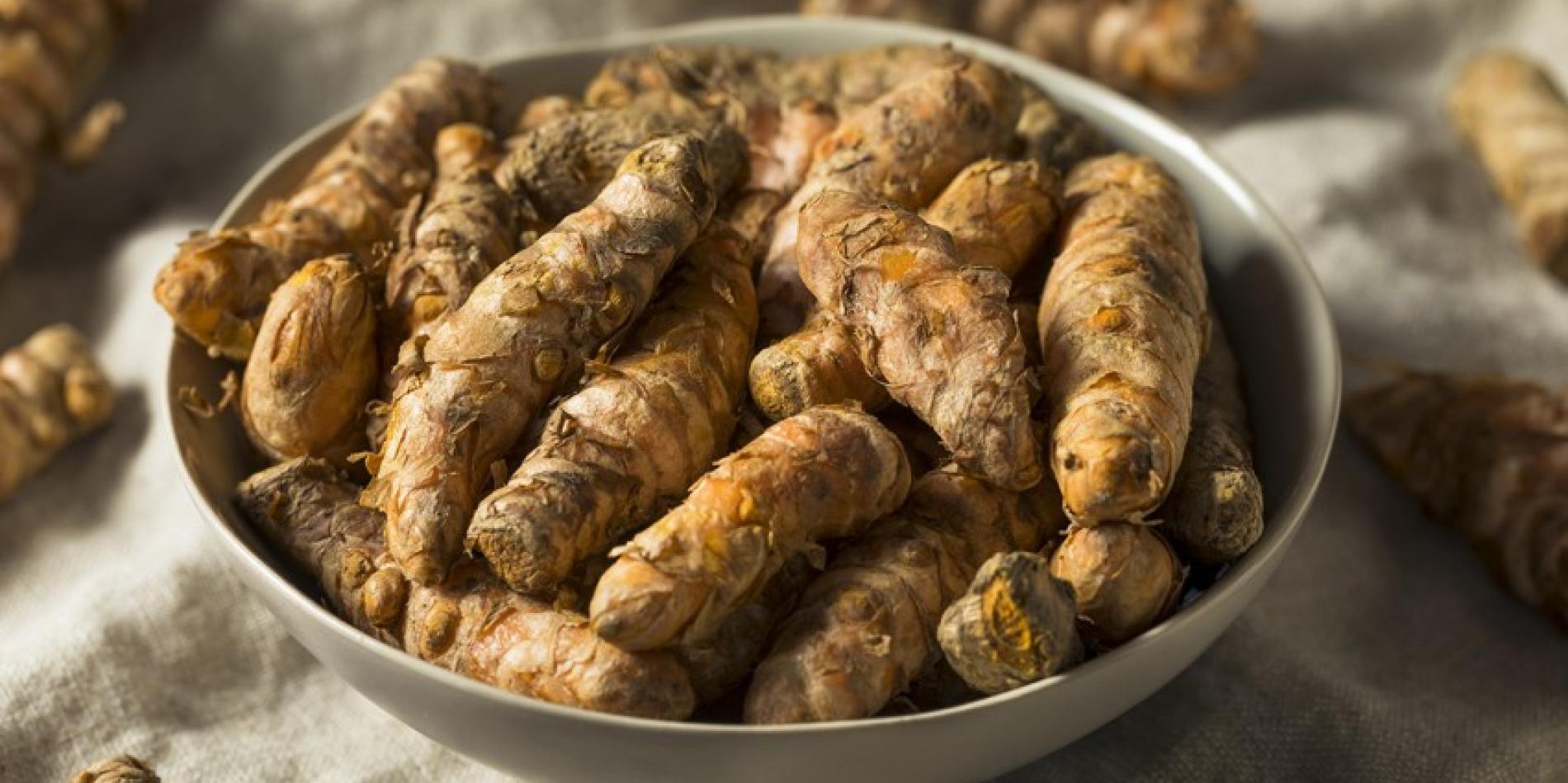 A white bowl full of tumeric