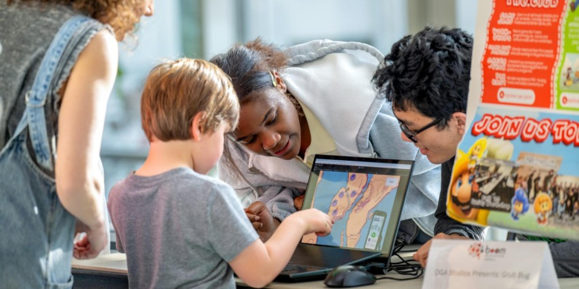 A young guest enjoys some of the technology on display at BOOM 2025.