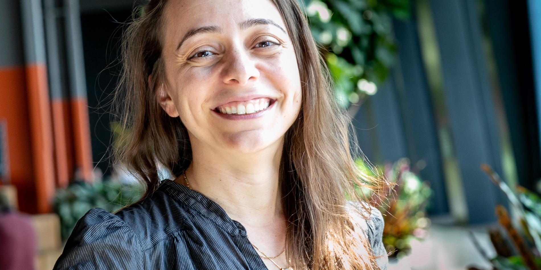 a white woman with long brown hair smiles 