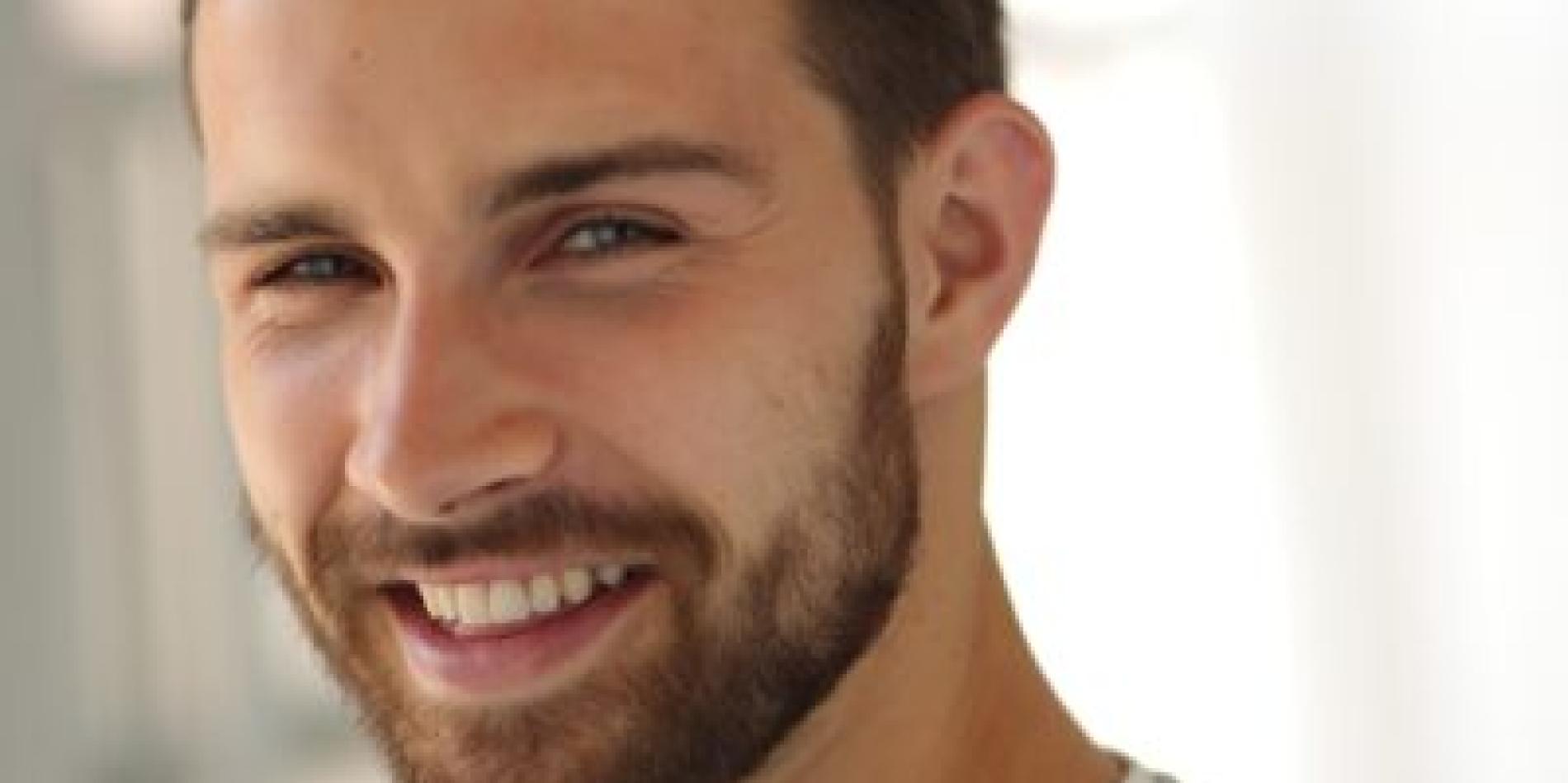 Yann Hicke wears a gray sweater and stares at the camera