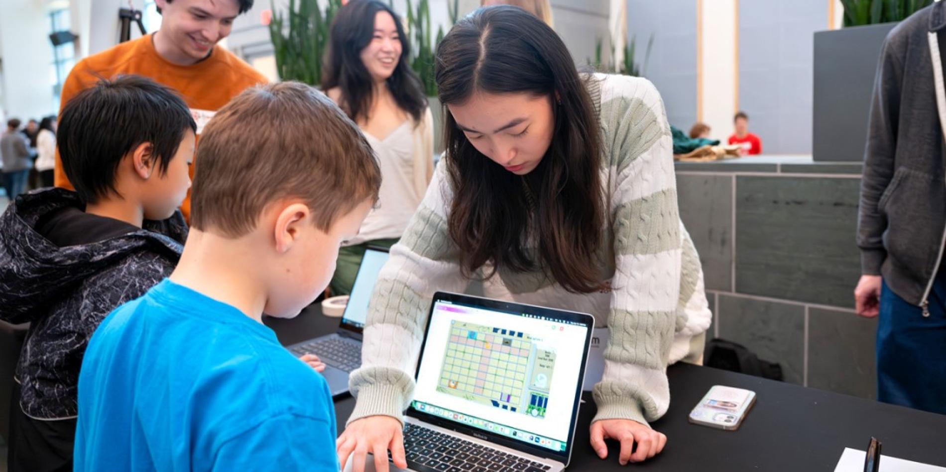 Young attendees try out new video games at BOOM 2024.