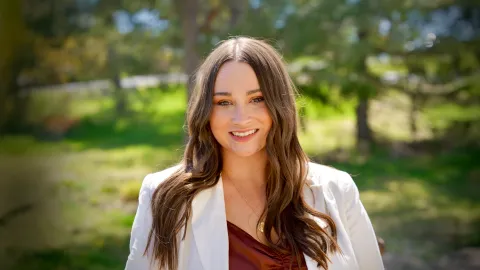 A color photo of Rebecca Fox standing outside