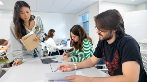 A color photo showing students working.
