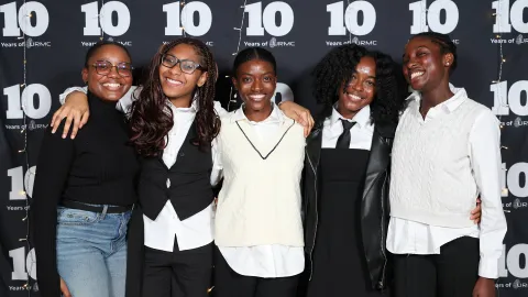 A color photo showing a group of women smiling for a photo.