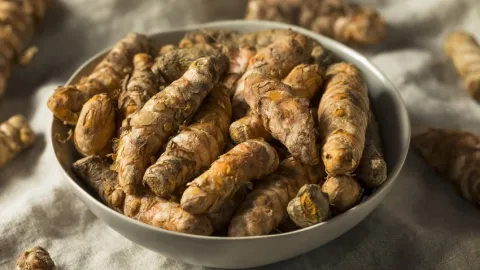 A white bowl full of tumeric
