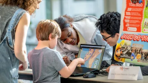 A young guest enjoys some of the technology on display at BOOM 2025.