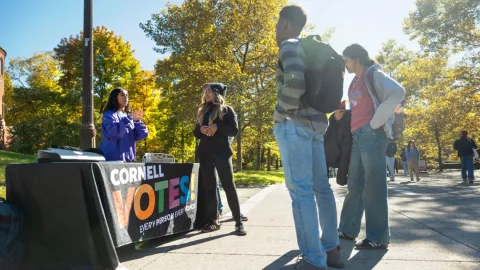Students from the Cornell Policy Group, a nonpartisan student organization, help others register to vote on Ho Plaza.