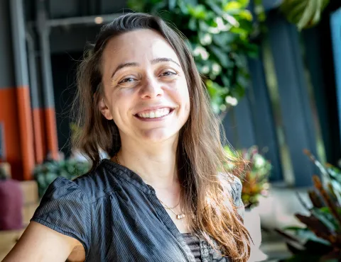a white woman with long brown hair smiles