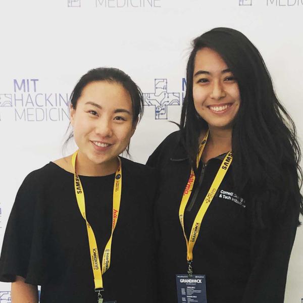 A color photo of 2 women smiling for a photo.