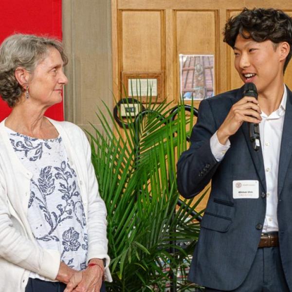 Minnue Uhm, right, speaks to attendees at the 37th Annual Merrill Presidential Scholars Luncheon about his high school Spanish teacher, Penelope Pendergrast, left.