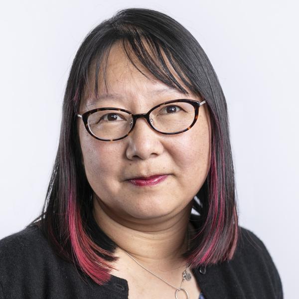 portrait of woman with medium length dark hair and glasses