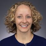 woman with blonde curly hair smiling