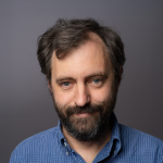 A color photo of man with beard and dark hair