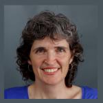 Portrait of woman smiling at camera, black curly hair