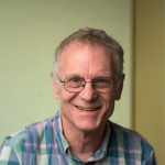 A photo of Dexter Kozen, a smiling man with short gray hair, glasses and a plaid shirt