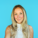 A color photo of a woman smiling for a photo.