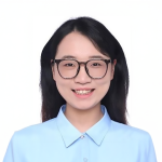A color photo of a woman smiling for a photo.