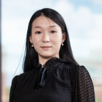 Woman in black shirt, looking at camera