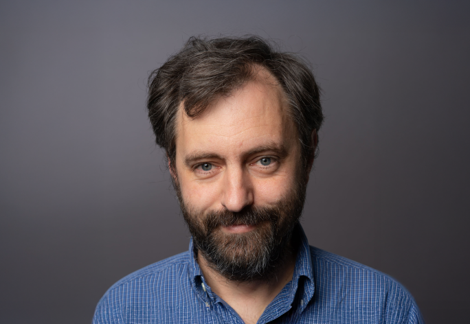 A color photo of man with beard and dark hair