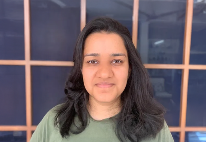 A photo of Tanya Goyal, a woman with shoulder-length dark brown hair in a green shirt.