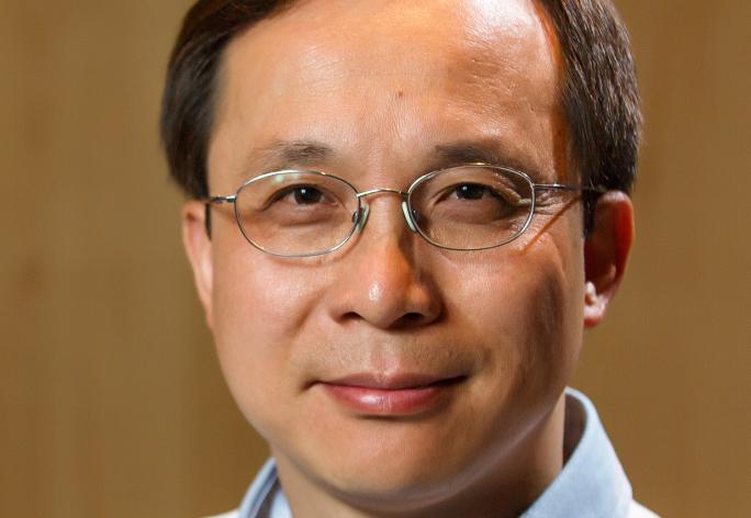 portrait of man with dark hair and glasses