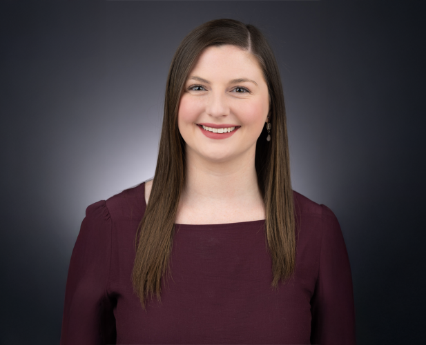 A color photo of Laura Schad in front of a dark background