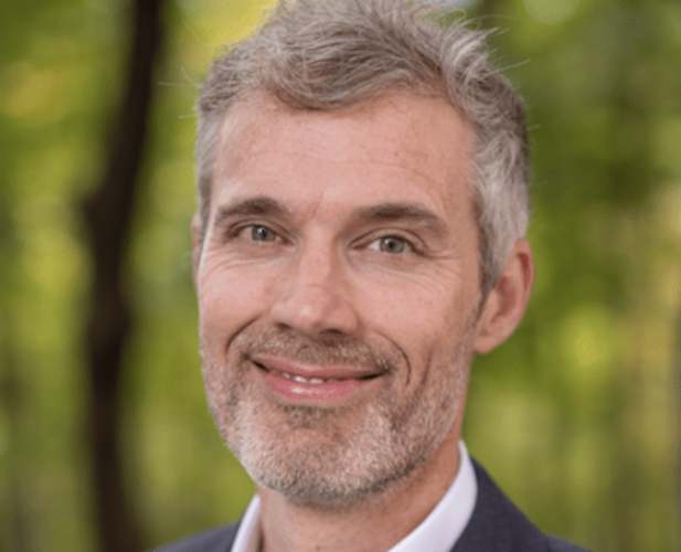 man in suit smiling at the camera