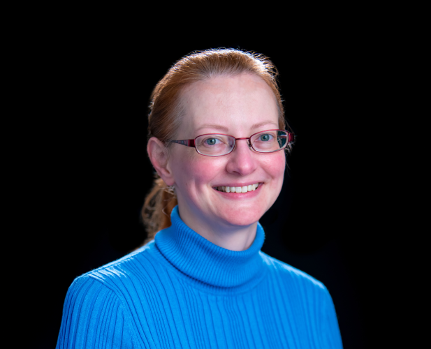 A color photo of Erin Pyrek in front of a black background