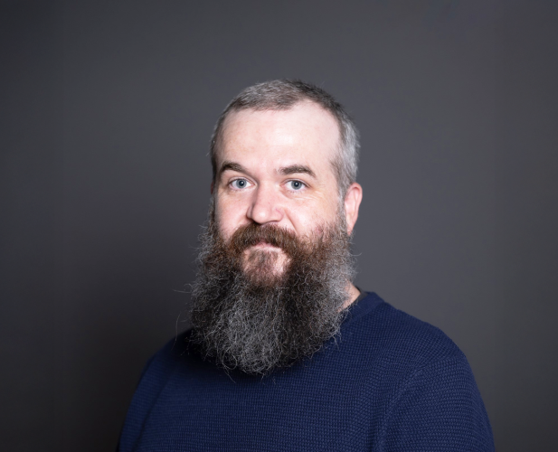 A color photo of Robert Nicholl in front of a grey background