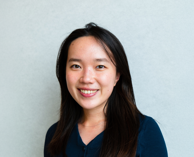 A color photo of a woman smiling for a photo.
