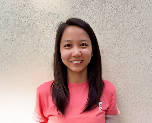 A color photo of a woman smiling for a photo.