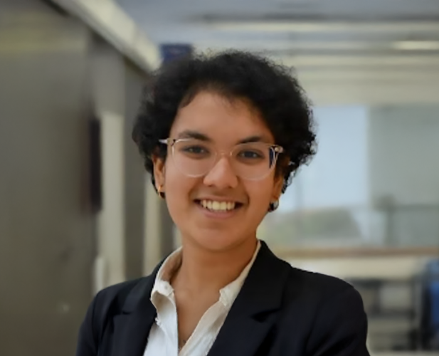 A color photo of a woman smiling for a photo.