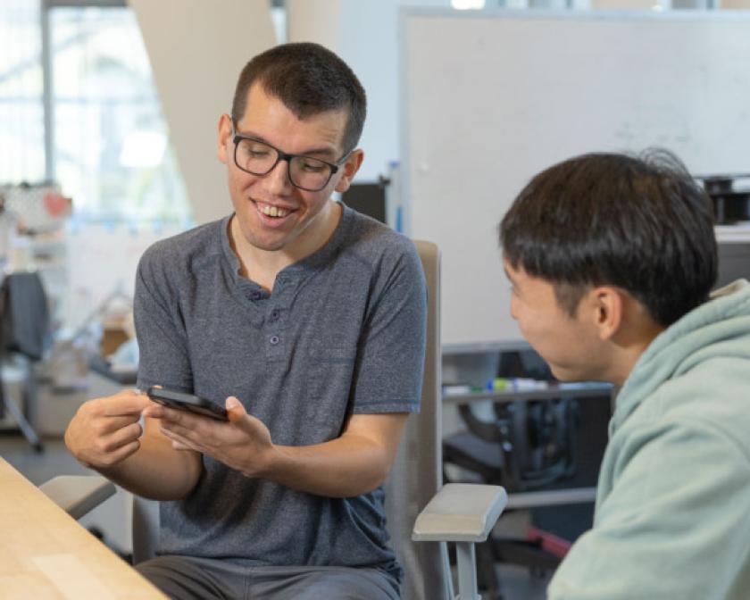 Doctoral student Tobias Weinberg communicates with another student using alternative AAC software on a smartphone