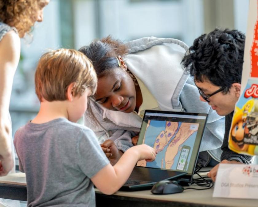 A young guest enjoys some of the technology on display at BOOM 2025.