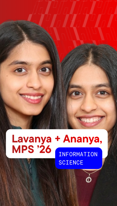 two female students with long dark hair smile against a bright red background