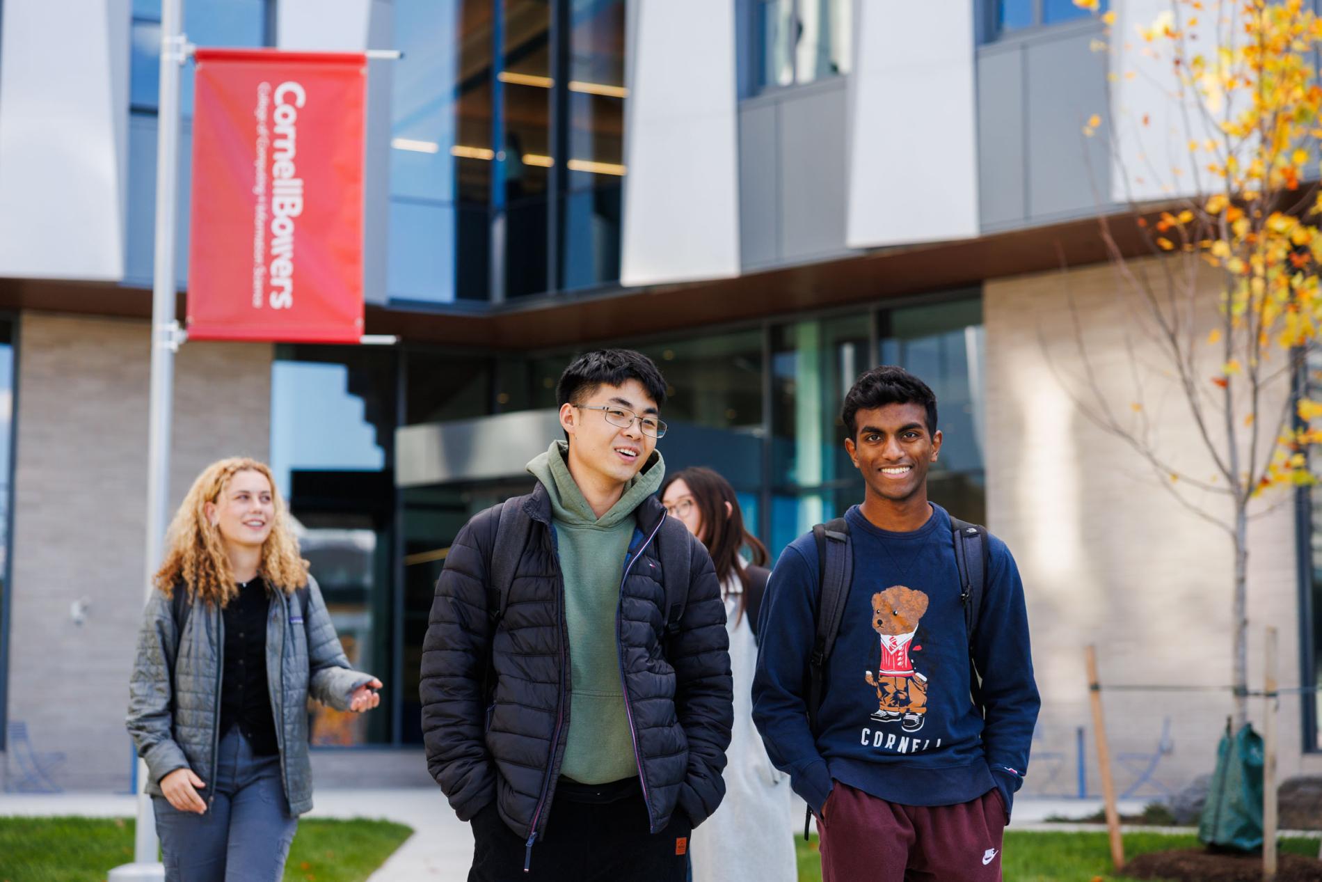 four students walking outside
